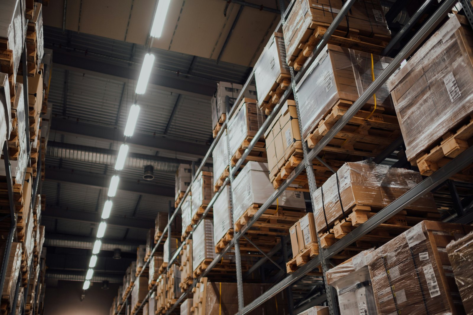 Warehouse shelving stacked with wrapped pallets of stock