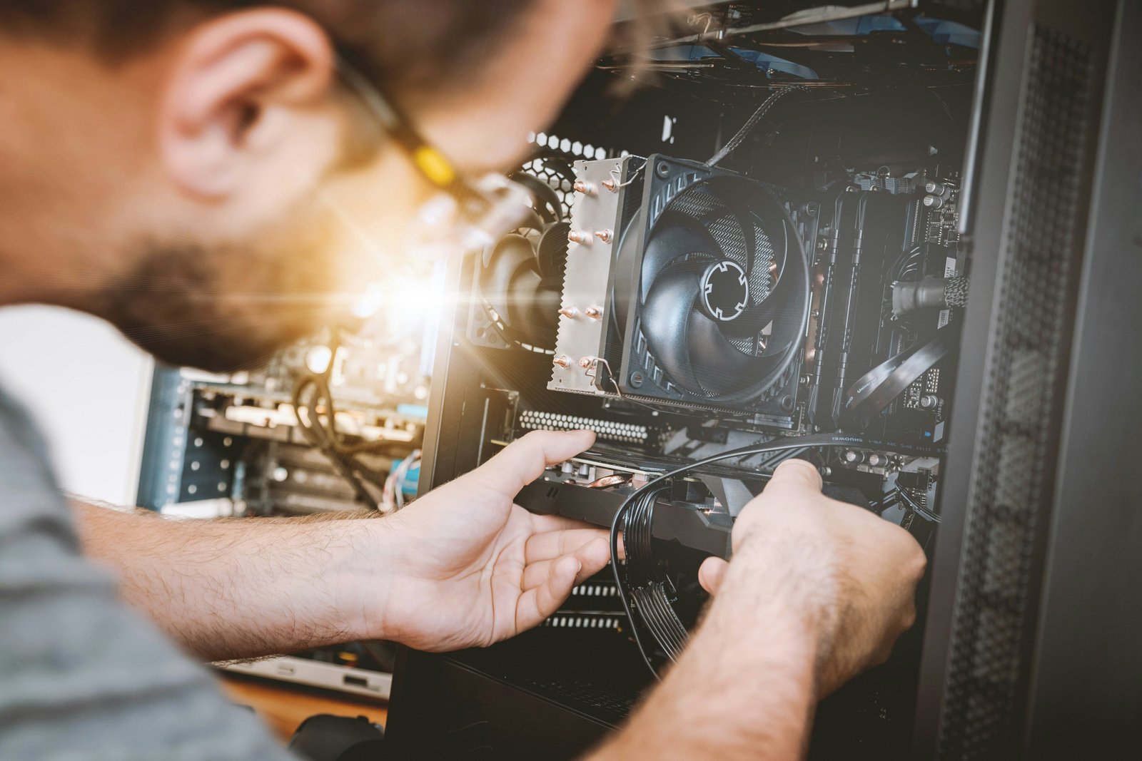 Technician installing and setting up computer hardware